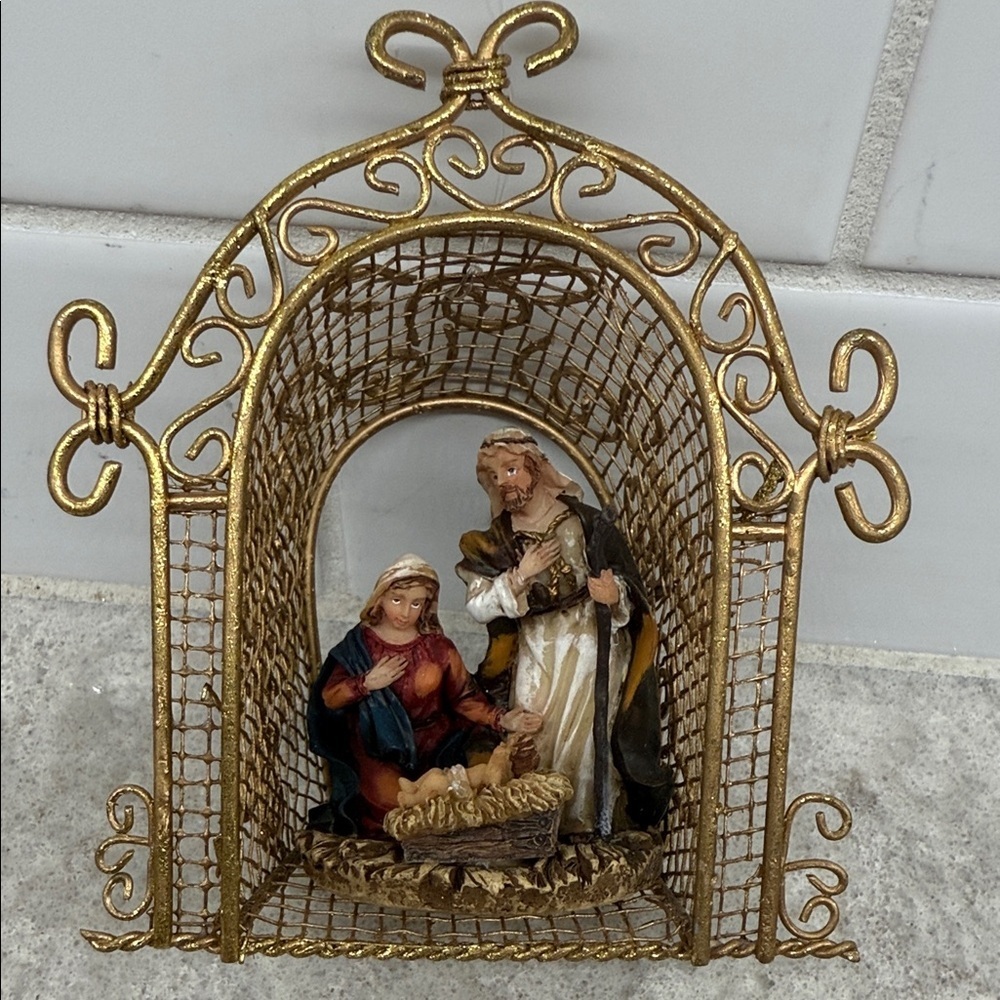 Gold Nativity Scene Christmas Ornament. 4.5x2x4 in. Metal and resin.